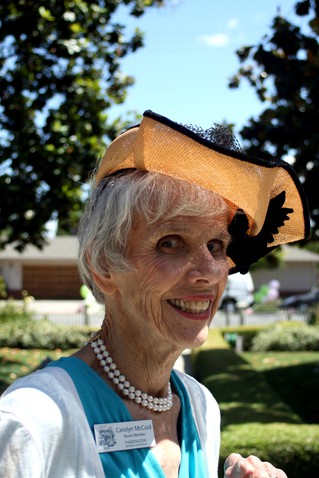 Board member Carolyn McCoid models a vintage hat