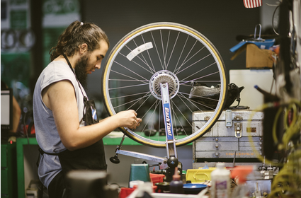 A trainee learns bicycle mechanics and repair at Good Karma's Park Tool School