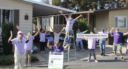 Rebuilding Together volunteers celebrate completing another successful home renovation project