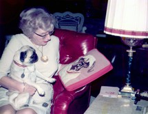 Dorothy and Flora examine a Pug needlepoint pillow, a gift from a friend